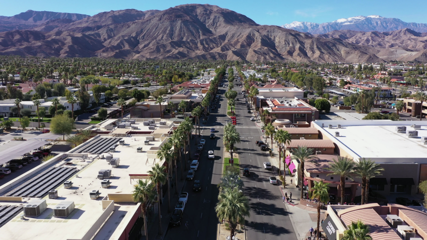 Daytime aerial view of the urban downtown area and mountains of Palm Desert, California, USA.