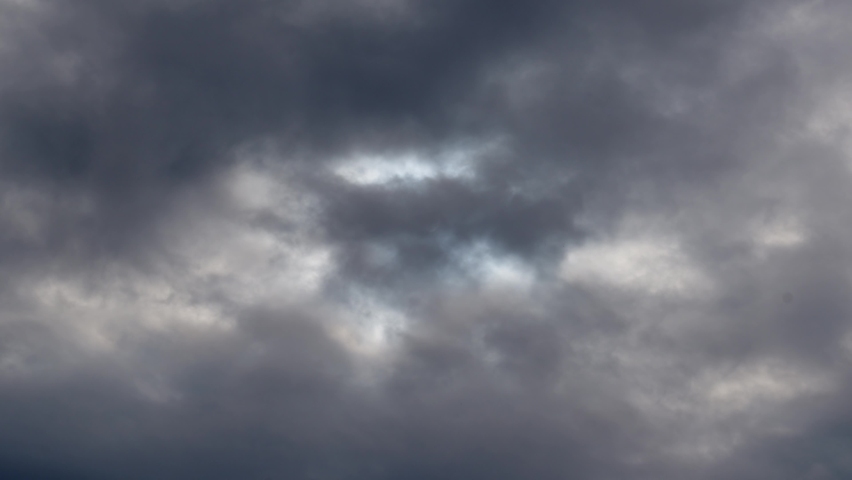 A solar eclipse in cloudy weather through a cloud. private solar eclipse. observation of natural phenomena. | Shutterstock HD Video #1097621711