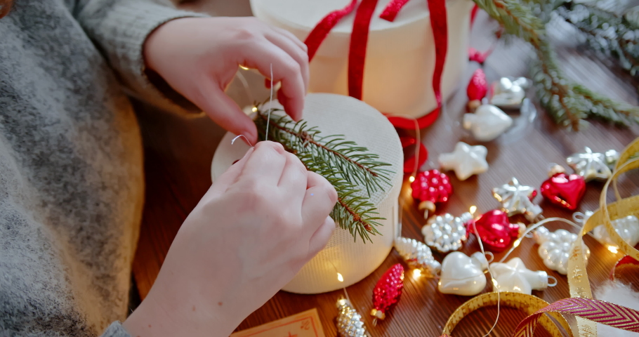Closeup of New Year's gift. The gift box is decorated with Christmas tree branch | Shutterstock HD Video #1097622829