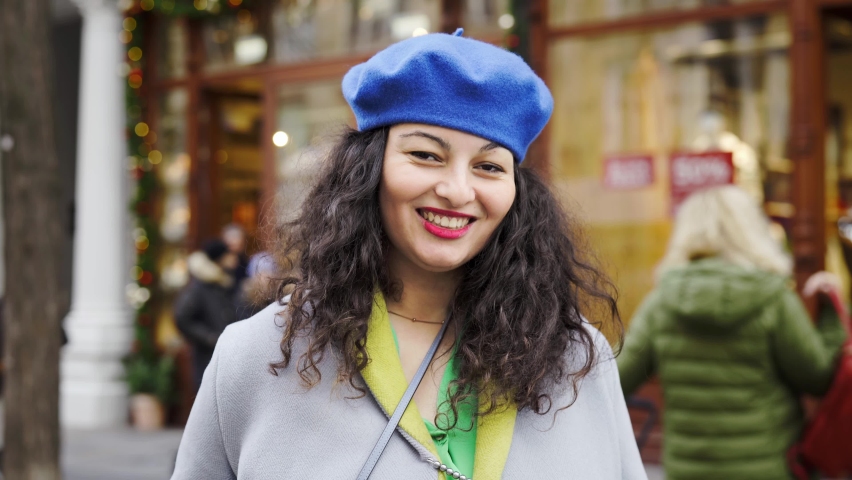 Portrait of bright smiling armenian woman outdoors. Christmas holidays