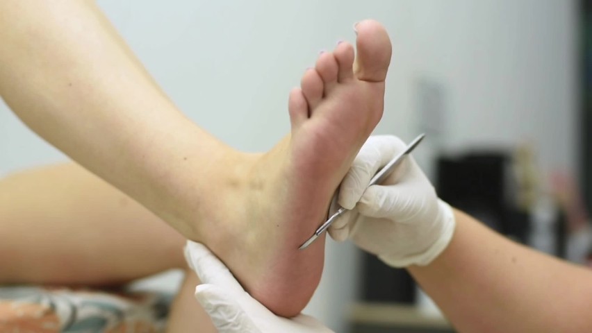Complete treatment of pedicure and podiatry for health, aesthetics and beauty of the feet and nails in an aesthetic center with a scalpel, file and creams