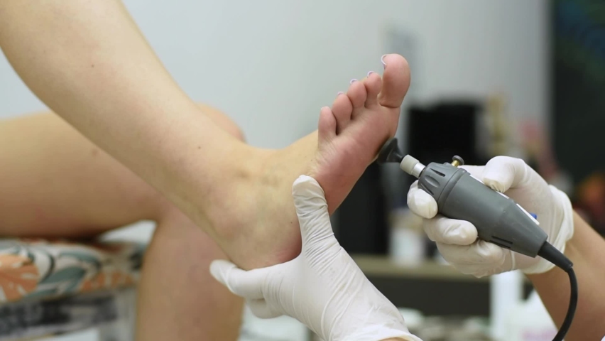 Complete treatment of pedicure and podiatry for health, aesthetics and beauty of the feet and nails in an aesthetic center with a scalpel, file and creams