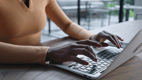 African American woman hands close up in cafe office working on laptop typing, freelance businesswoman video call chatting typing message