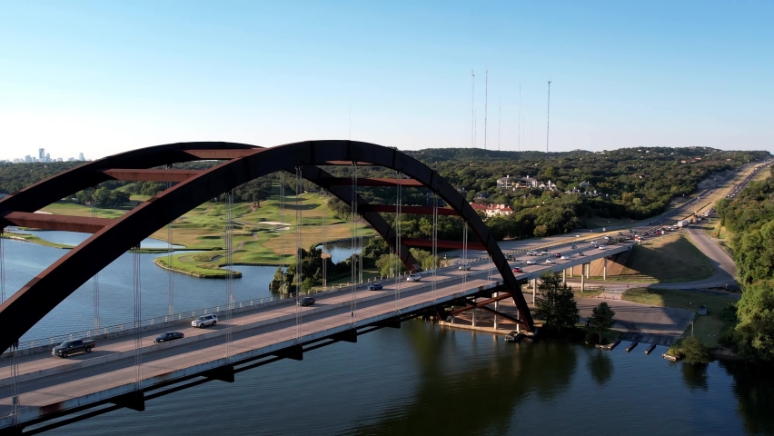 Aerial drone forward moving shot over Pennyback bridge in Austin, Texas, USA with a top down view of Lake Austin on a bright sunny day.