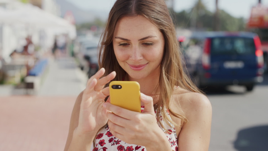 Summer tourist, woman texting on street and phone app with smile, reading or social media on walk. Happy girl, travel or walking with smartphone, happiness or chatting in sunshine in Rio de Janeiro | Shutterstock HD Video #1097632293