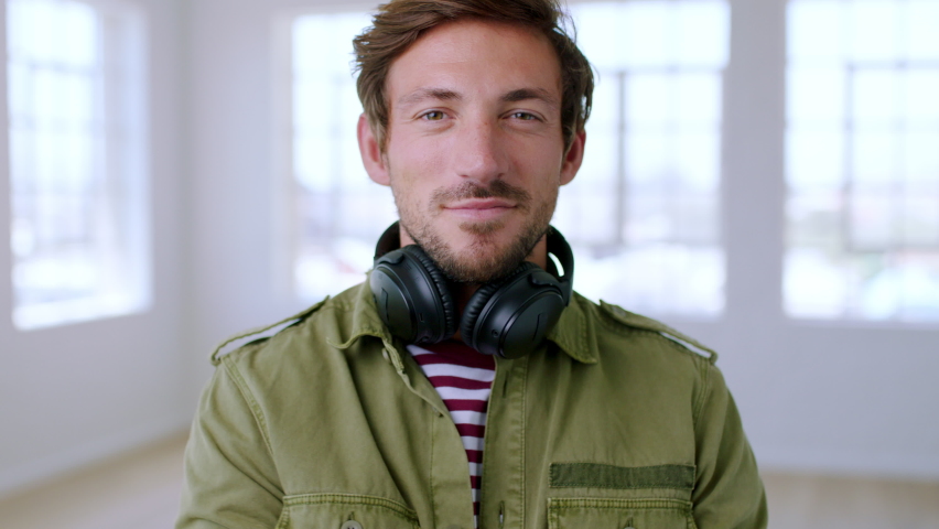 Portrait of geek, man and hipster with headphones for music, podcast and audio playlist in Australia. Happy, trendy and smile young graphic designer, nerd and IT guy listening to song, radio or track
