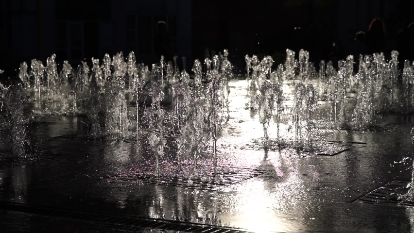 Water jets from the city fountain in the park in the sunset sunlight. Water pressure and pressure. Splashing water. Slow motion. Close up | Shutterstock HD Video #1097633025