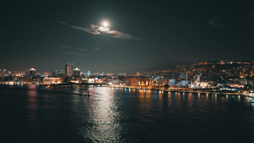 Aerial night shot over the sea with the ferryboats and city views in Konak Izmir Turkey | Shutterstock HD Video #1097633895