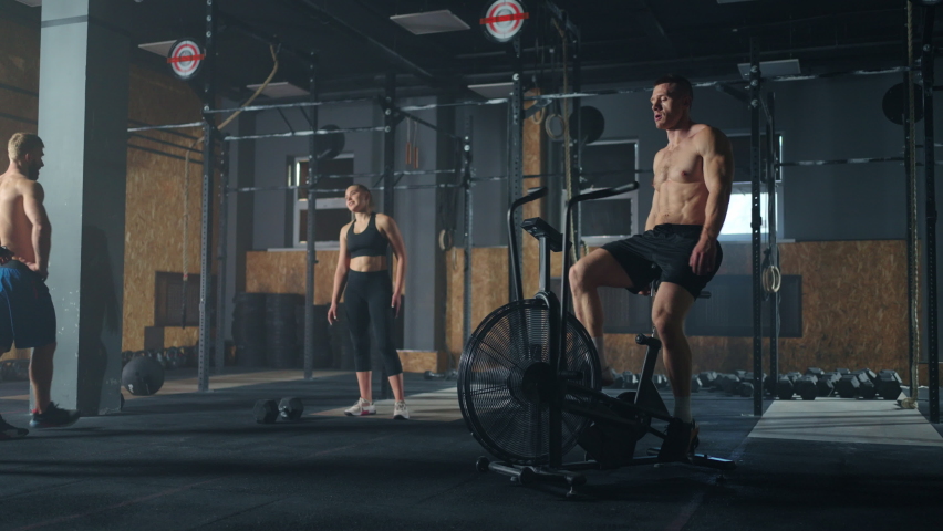 inside modern fitness club for professional sportsperson, man exercicing on stationary bike