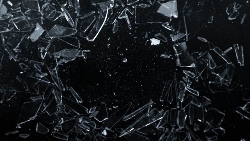 Super Slow Motion Shot of Glass Shards Flying Towards Camera Isolated on Black at 1000fps. Royalty-Free Stock Footage #1097636915