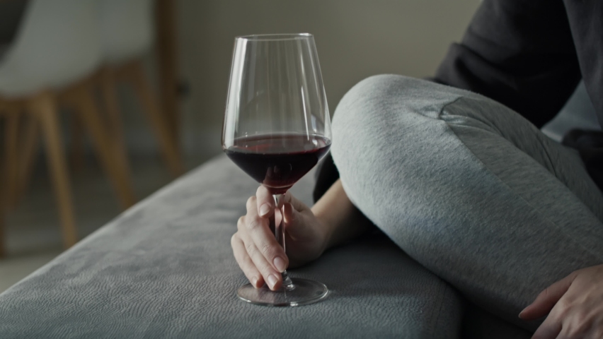 Caucasian woman with problems drinking red wine at home. Shot with RED helium camera in 8K. | Shutterstock HD Video #1097638353