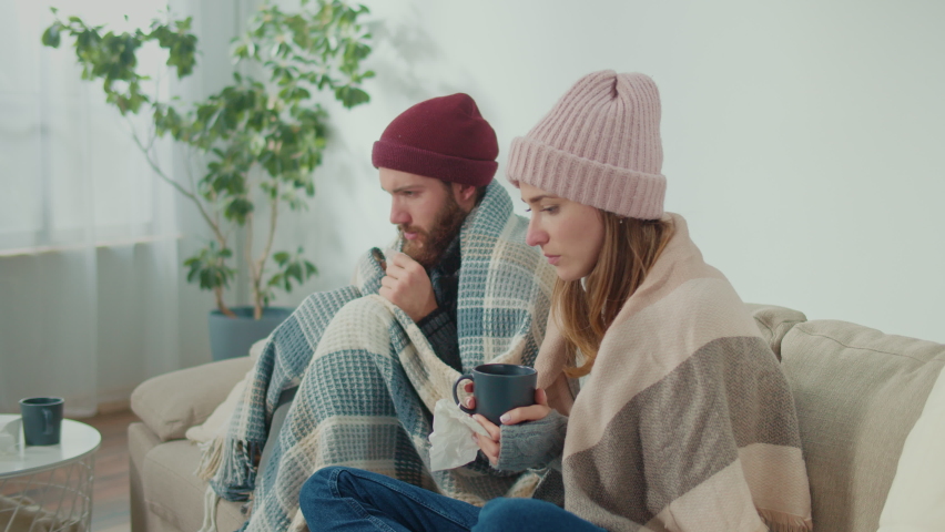 Unhealthy Couple Feeling Cold Fever Freezing Central Heating Problem at Home Covering With Plaid, Sneezing, Wiping Runny Nose with Paper Tissue, Feeling Unwell, Curing Flu with Pills | Shutterstock HD Video #1097639347