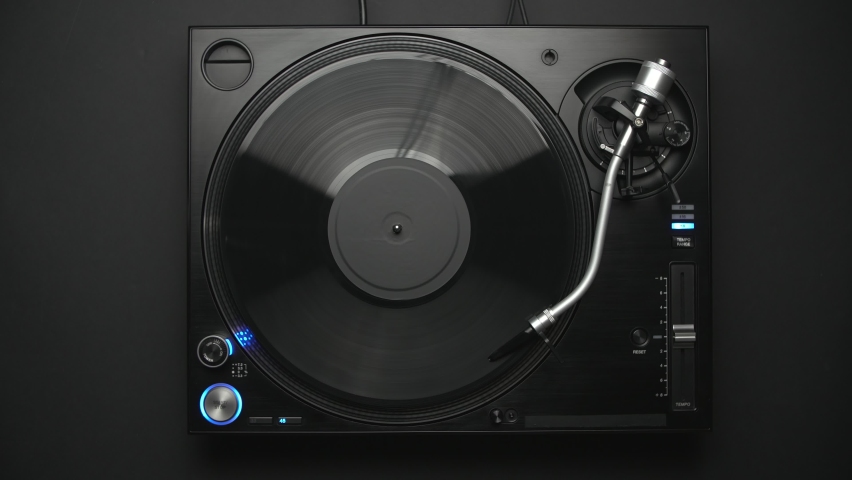 DJ turntable in flat lay video. Analog disc jockey record player with vinyl disc filmed directly from above Royalty-Free Stock Footage #1097640865