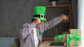 Male fan in leprechaun hat watching football play online broadcast on St.Patrick's Day on laptop, betting at bookmaker website. Lucky man celebrating victory after winning jackpot in casino. - Powered by Shutterstock - Get 15% off with code: PIKWIZARD15