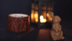Lighting candles. A burning candle in the shape of a rabbit. Holiday advent. Beautiful handmade candles. Cozy atmosphere in the house. Background video