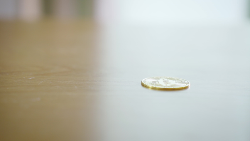 CloseUp Slow motion Business man Counting BitCoin digital gold on wooden table.