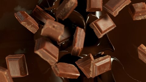 Super Slow Motion of Falling Chocolate Pieces into Melted Chocolate. Filmed with High Speed Cinema Camera, 1000fps. ஸ்டாக் வீடியோ