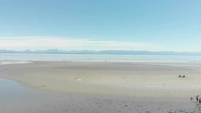 An Drone view of Miracle Beach shoreline and its beautiful blue sky in Provincial Park, BC, Canada