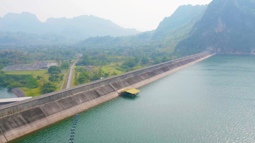 Aerial view of dam tower crane. Reservoir and sea water in recycle energy industry concept for electricity in Natural landscape background. Environment.