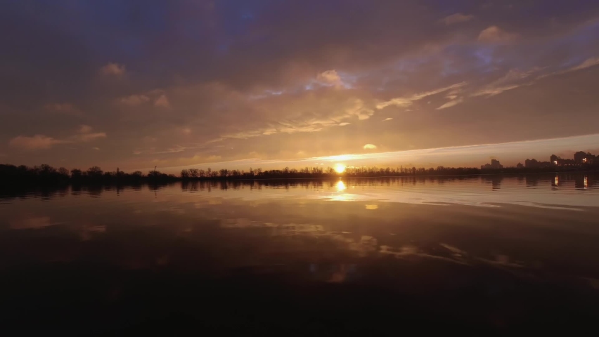 Colorful timelapse of a red sunset over a lake, privacy in nature.