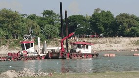 Cinematic video of  dredger boat dredging sand in the river bank at Brahmaputra river