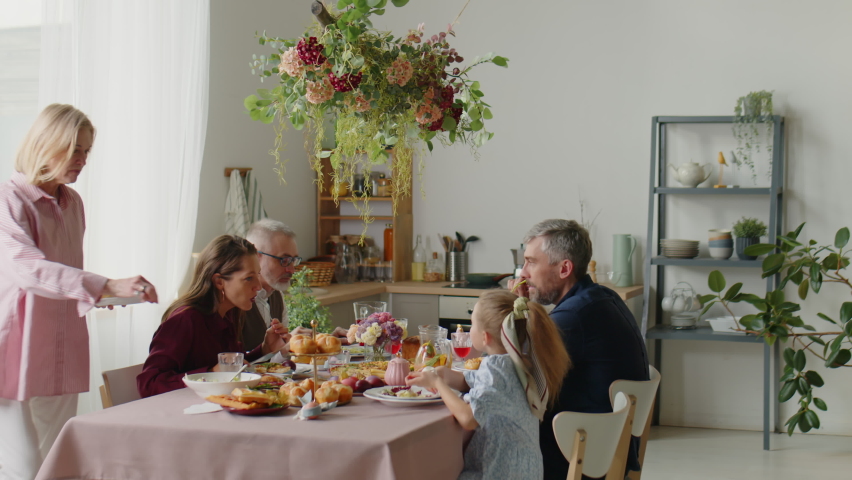 Big family eating meal at holiday dinner while celebrating Easter together at home Royalty-Free Stock Footage #1097665583