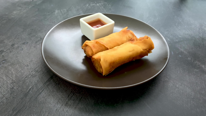 Dipping Spring Rolls into Sweet and Sour Sauce Royalty-Free Stock Footage #1097665761
