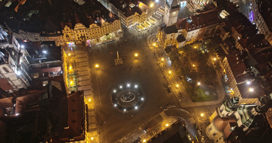 Prague Czechia Aerial v36 night hyperlapse capturing lively old town square, tilt up reveals downtown cityscape with iconic landmarks turning the lights off - Shot with Mavic 3 Cine - October 2022
