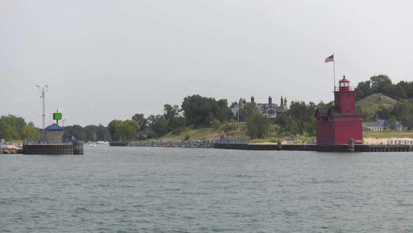 Lighthouse at the entrance to the Holland Michigan harbor. Shot features the lighthouse framed to the right with the harbor entrance. This lighthouse has strong Dutch architectural influences.