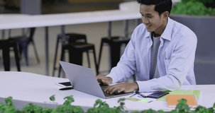 4K Video slow motion asian man in casual dress working in outdoor office. Concept for working in open office and work from outdoor.