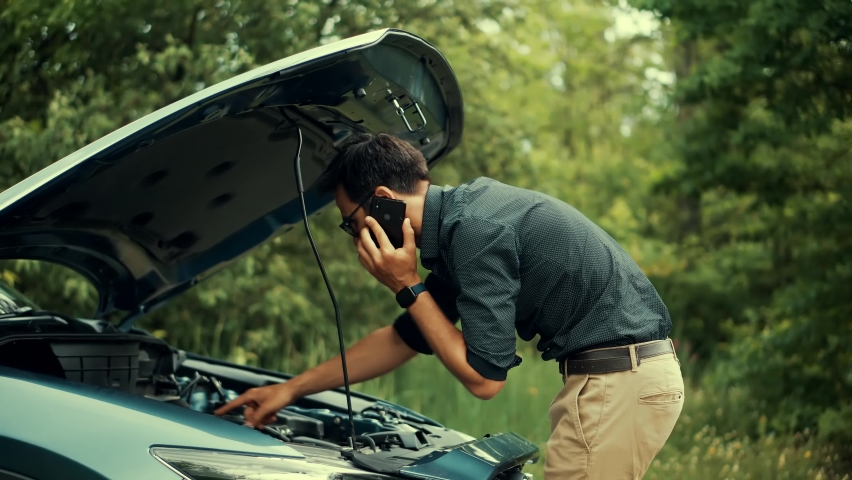 Broken Car At Road Trip. Driver Open Hood Inspecting Auto. Overheating Engine On Vehicle. Calling Car Service. Towing Assistance Evacuation Damage. Auto Repair Automotive Service. Car Accident Failure Royalty-Free Stock Footage #1097676487