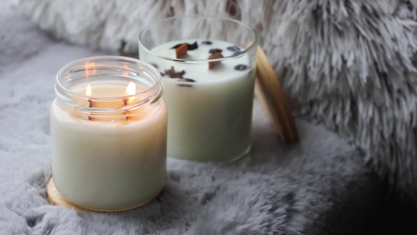 Beautiful handmade scented candles. A candle is burning. Cozy atmosphere in the house.  Royalty-Free Stock Footage #1097681673