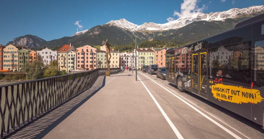 Innsbruck austria walking on bridge old town view buildings colored alps mountains winter snow.