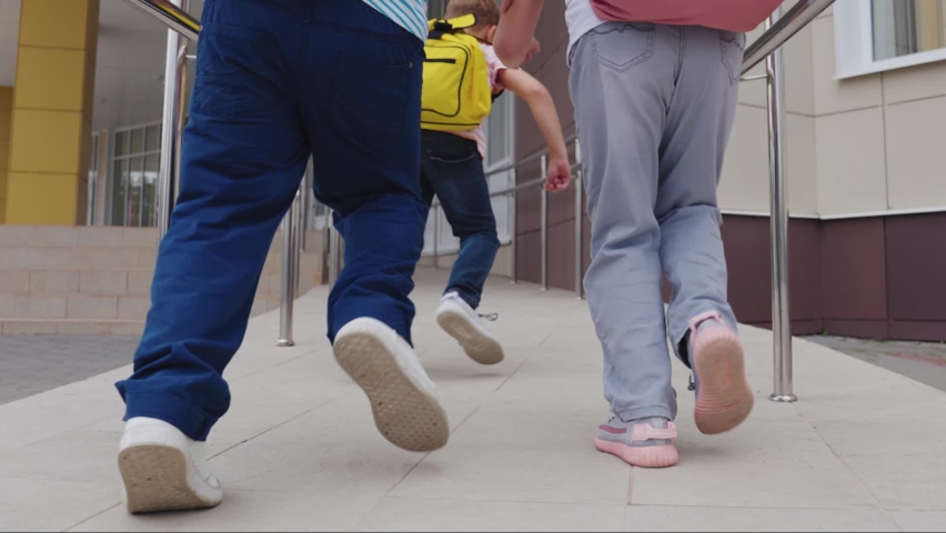 little children run school lesson. group children with school backpack merrily run class. happy kid. American child education. teamwork. student school educational institution. call lesson concept. Royalty-Free Stock Footage #1097685647