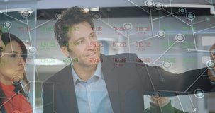 Animation of financial data processing over diverse business people working at office. Global business, finances and digital interface concept digitally generated video.