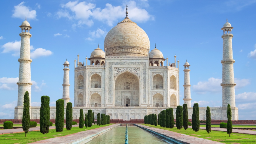4K time lapse of Taj Mahal, an ivory-white marble mausoleum on the south bank of the Yamuna river. One of the seven wonders of the world. Royalty-Free Stock Footage #1097688599