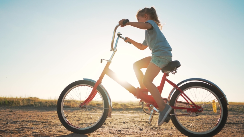 Happy family concept. Kid learn to ride bike. Child rides a bicycle on rural road. Children outdoors in summer. Bicycle travel.Cheerful kid rides bicycle in park in summer. go everywhere.Happy family Royalty-Free Stock Footage #1097692081