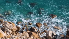 Aerial FHD footage of seashore in sunny day. Beautiful sea surface nature view. Top down bird eye view. Slow motion video.