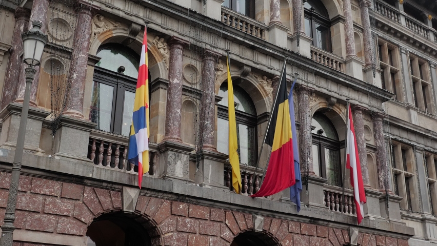 Flags of various European countries and European Union waving in front of city administration building, Antwerp, Belgium. Large Belgian National flag waving in Antwerpen. City Hall Antwerp Belgium