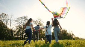happy family. big family running with a kite. people in the park children child running together in the park at sunset silhouette. mom dad daughter and son are running. concept dream. kids fun run - Powered by Shutterstock - Get 15% off with code: PIKWIZARD15