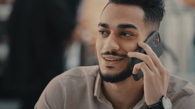 Ethnic Indian man laughing talking mobile phone speak with telephone cell gadget. 30s guy male worker manager businessman smiling laugh friendly happy answering communicate talk mobile call discuss - Powered by Shutterstock - Get 15% off with code: PIKWIZARD15