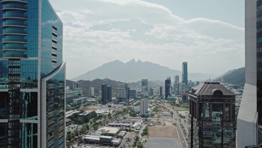 AERIAL - San Pedro financial business district, mountains, Monterrey, Mexico, reverse Royalty-Free Stock Footage #1097700957
