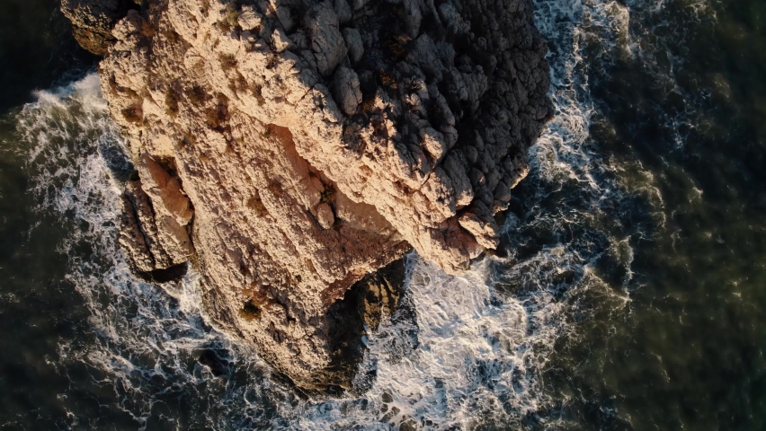 Drone head shot of Waves Crashing Rocks. Peñón, offshore rocky island fortress. 