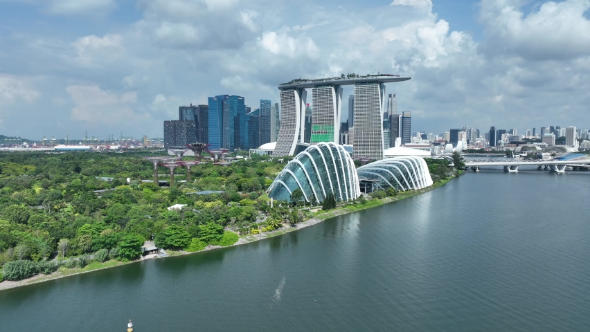 Singapore drone pull away shot over the Marina Bay, looking at Marina Bay Sands and Botanical Garden Flower Domes Royalty-Free Stock Footage #1097701409