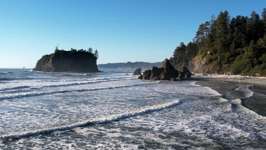 Aerial shot of sea waves crashing on the beach with people enjoying the scenery. Horizontal Photo of Ruby Beach in Olympic National Park Washington State
