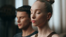 Portrait of calm meditating couple with closed eyes in room close up. Happy married pair practicing yoga together doing relaxing exercise at home. Blond wife feeling harmony with sporty husband. - Powered by Shutterstock - Get 15% off with code: PIKWIZARD15