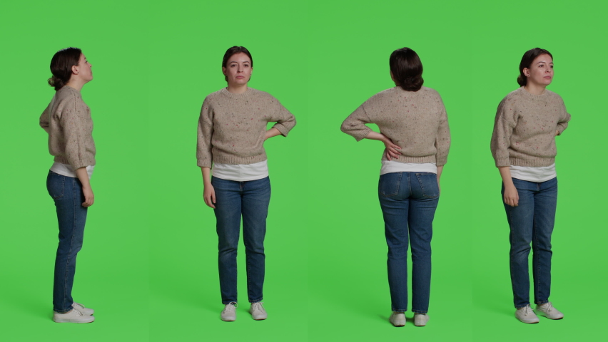 Caucasian woman greeting someone with wave, smiling on camera. Relaxed casual girl waving hi or hello in studio, standing over full body green screen background and saying goodbye or greet.