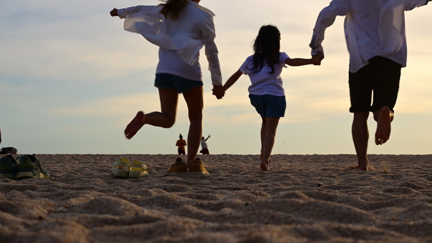 Happy family enjoying with beautiful sky view at sunset running together on sandy beach, Family on beach holiday vacation, Family with beach travel, Freedom and travel concept | Shutterstock HD Video #1097719639