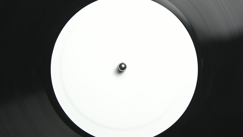 Vinyl record spinning on turntable. Flat lay video clip of analog disc with music filmed on dj player from above Royalty-Free Stock Footage #1097720099