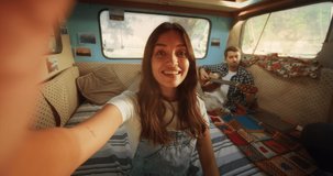 Beautiful Young Female Having a Video Call with Family or Friends from a Vacation Camping Motorhome Spot. Girl Waving to Say Hello and Asking Her Boyfriend to Join the Conversation. POV Footage.